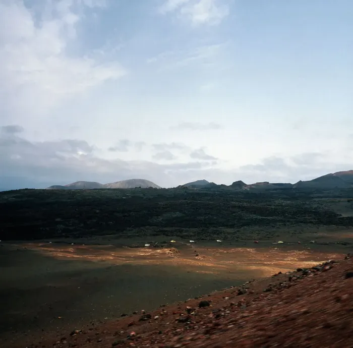 Impression encadrée : Lanzarote. Voitures-camions en distance à un excursion dans les montagnes