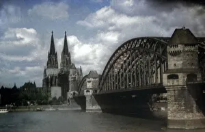 Prints of Der Hohe Dom zu Köln und die Hohenzollernbrücke, Deutschland 1930er Jahre. Cologne cathedral and Hohenzollernbruecke bridge over River Rhine, Germany 1930s Jakob Volk Prints: Köln