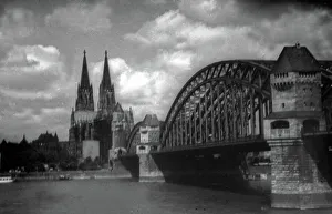 Prints of Der Hohe Dom zu Köln und die Hohenzollernbrücke, Deutschland 1930er Jahre. Cologne cathedral and Hohenzollernbruecke bridge over River Rhine, Germany 1930s Jakob Volk Prints: Köln