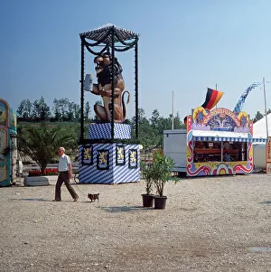 Prints of München, 1985. Rummelplatz mit Löwenbräu Brauerei Symbolfigur. Munich, 1985. Fairground with Löwenbräu symbol stand Walter Rudolph Prints: München